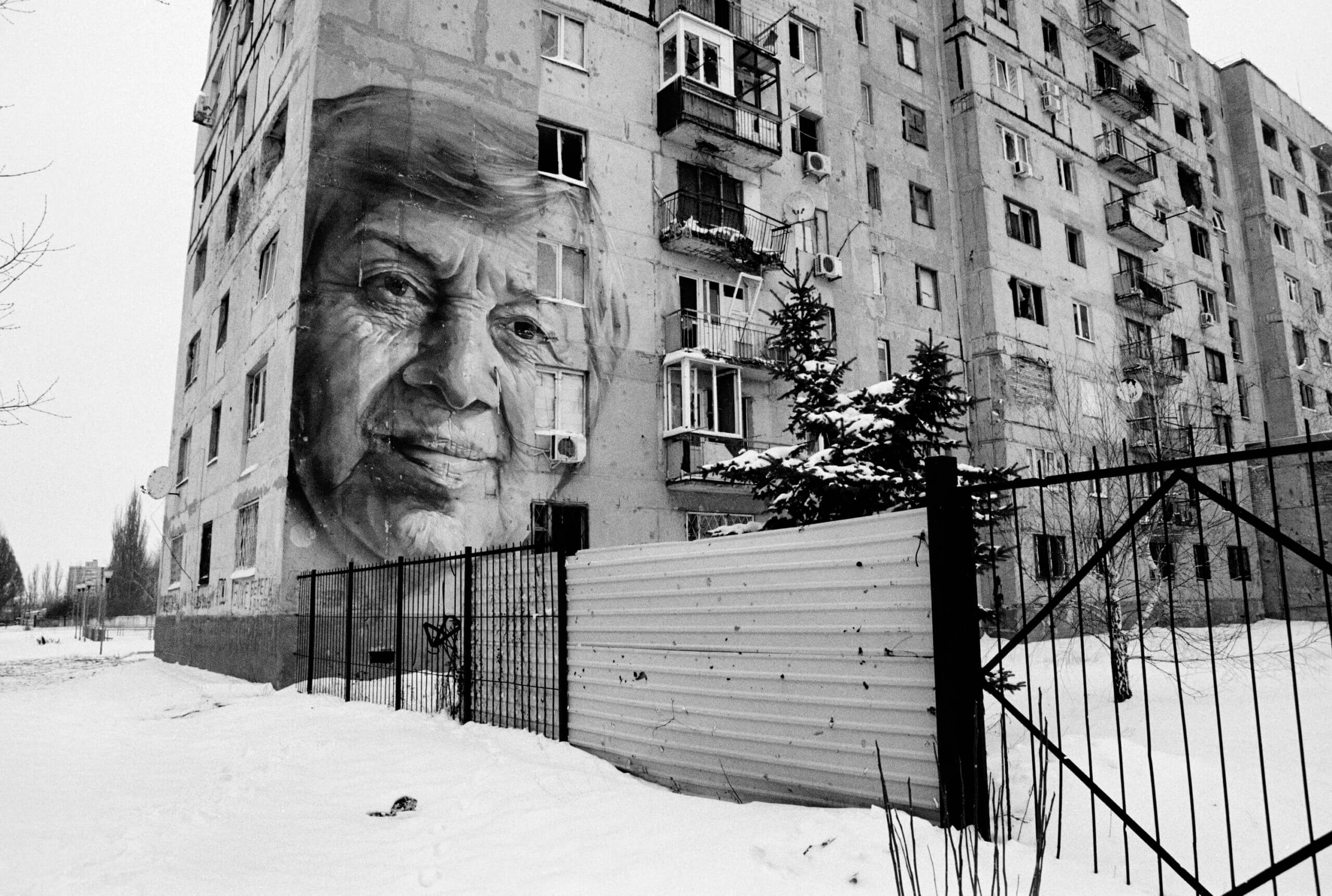 Tower block with street art of old woman's face