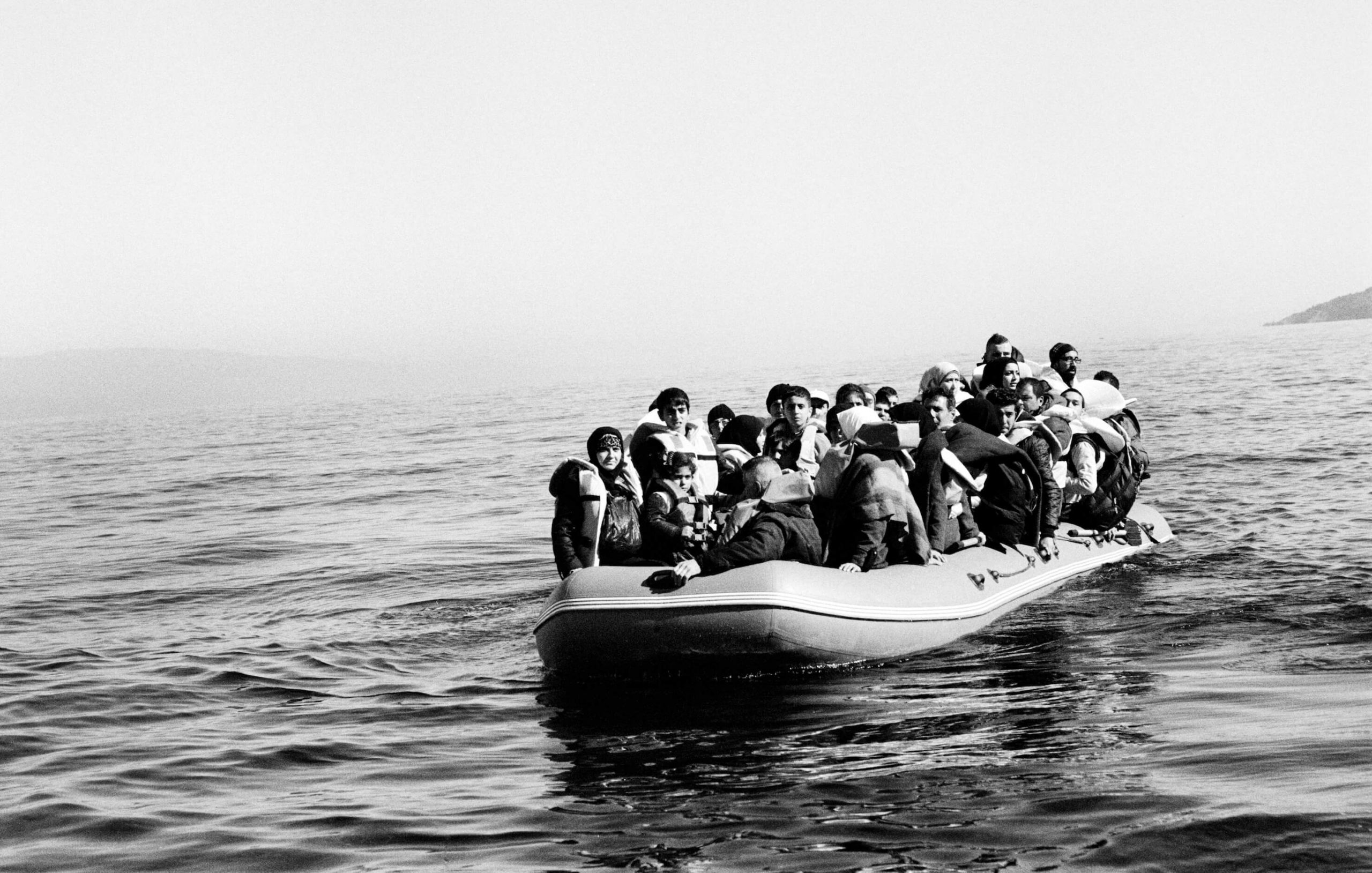 A boat carrying Syrian refugees drifts in the Aegean
